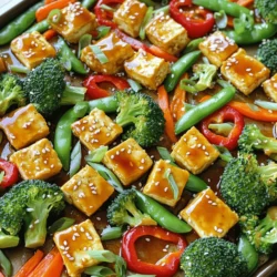 Tofu ist ein großartiger Fleischersatz. Es gibt verschiedene Arten von Tofu. Fester Tofu hält seine Form gut und hat eine gute Textur. Seidentofu ist weicher und eignet sich eher für Saucen. Für dieses Rezept nehmen wir festen Tofu. Er nimmt die Aromen gut auf und wird schön knusprig beim Backen. Für ein buntes und gesundes Gericht sind Gemüse wichtig. In diesem Rezept verwenden wir: - 2 Tassen Brokkoliröschen - 1 rote Paprika, in Streifen geschnitten - 1 Karotte, dünn aufgeschnitten - 1 Tasse Zuckerschoten Diese Gemüse sind knackig und bringen Farbe auf den Teller. Brokkoli hat viele Vitamine. Paprika gibt einen süßen Geschmack. Karotten sind knackig und Zuckerschoten sind süß. Zusammen ergeben sie eine tolle Mischung. Die Teriyaki-Sauce macht das Gericht besonders lecker. Hier sind die Zutaten: - 60 ml natriumarme Sojasauce - 30 ml Honig oder Ahornsirup - 30 ml Reisessig - 30 ml Sesamöl - 1 Esslöffel frischer Ingwer, gerieben - 2 Knoblauchzehen, fein gehackt Um die Sauce zu machen, mischen Sie alle Zutaten in einer kleinen Schüssel. Rühren Sie gut um, bis alles vermischt ist. Diese Sauce gibt dem Tofu und dem Gemüse einen tollen Geschmack. Die Süße vom Honig oder Ahornsirup passt perfekt zur Sojasauce. Zuerst heize den Ofen auf 200°C vor. Das Backblech mit Backpapier auslegen, hilft bei der Reinigung. Während der Ofen aufheizt, schneide den Tofu in gleichmäßige Würfel. Achte darauf, dass der Tofu gut abgetropft ist. So wird er beim Backen knusprig und lecker. Bereite auch das Gemüse vor: schneide die Paprika in Streifen, die Karotte in dünne Scheiben und wasche den Brokkoli. So sparst du Zeit beim Kochen. Gib die Tofuwürfel in eine mittelgroße Schüssel. In einer kleinen Schüssel mische die Sojasauce, den Honig oder Ahornsirup, den Reisessig, das Sesamöl, den Ingwer und den Knoblauch. Diese Mischung gibt dem Tofu tollen Geschmack. Gieße die Hälfte der Teriyaki-Sauce über den Tofu. Lass ihn etwa 15 Minuten marinieren. So absorbiert der Tofu die Aromen gut. Bewahre die andere Hälfte der Sauce für später auf. Jetzt kommt der spaßige Teil! Verteile das vorbereitete Gemüse auf einer Seite des Backblechs. Auf der anderen Seite platzierst du den marinierten Tofu. Träufle die restliche Teriyaki-Sauce über das Gemüse und den Tofu. So wird alles schön gewürzt. Schiebe das Backblech in den Ofen und backe alles für 25-30 Minuten. Denk daran, einmal während des Backens umzurühren. So wird das Gemüse zart und der Tofu goldbraun. Nach dem Backen ist das Gericht bereit zum Servieren. Um den Tofu knusprig zu machen, drücken Sie ihn gut aus. Entfernen Sie so viel Wasser wie möglich. Schneiden Sie den Tofu in gleichmäßige Würfel. Eine gute Marinade hilft, den Geschmack zu verstärken. Lassen Sie ihn mindestens 15 Minuten in der Teriyaki-Sauce ziehen. Backen Sie den Tofu auf einem heißen Blech. Das sorgt für eine schöne Kruste. Rühren Sie den Tofu während des Backens einmal um. So wird er gleichmäßig knusprig. Sie können viele verschiedene Gemüse verwenden. Brokkoli, Paprika und Karotten sind großartig. Zucchini, Auberginen oder Pilze passen auch gut. Frisches Gemüse bringt Farbe und Geschmack. Schneiden Sie das Gemüse in gleichmäßige Stücke. So garen sie gleichmäßig und bleiben knackig. Experimentieren Sie mit verschiedenen Gemüsesorten. So bleibt das Gericht spannend und lecker. Zu Teriyaki-Tofu passen verschiedene Beilagen. Reis oder Quinoa sind die Klassiker. Sie nehmen die Sauce gut auf. Auch gebratene Nudeln sind eine tolle Wahl. Für einen frischen Touch können Sie einen Salat servieren. Ein einfacher Gurkensalat passt gut dazu. So haben Sie eine schöne Balance zwischen warm und frisch. {{image_4}} Um das Rezept vegan zu machen, ersetzen Sie den Honig durch Ahornsirup. Ahornsirup ist ein toller Ersatz, der die Süße beibehält. Verwenden Sie auch eine vegane Sojasauce. Diese ist oft als „Tamari“ bekannt. Tamari ist glutenfrei und hat einen starken Geschmack. So bleibt die Sauce vollmundig und lecker. Für eine glutenfreie Variante nutzen Sie Tamari statt normaler Sojasauce. Achten Sie darauf, dass alle anderen Zutaten auch glutenfrei sind. Viele Marken bieten glutenfreie Reisessige an. Diese sind leicht zu finden und passen gut in das Rezept. So bleibt das Gericht für alle genießbar. Sie können viele verschiedene Gemüsesorten verwenden. Zucchini, Auberginen oder Paprika sind gute Optionen. Auch Spargel oder Kürbis verleihen dem Gericht einen neuen Geschmack. Schneiden Sie das Gemüse in gleich große Stücke. So garen sie gleichmäßig. Experimentieren Sie mit Ihren Lieblingsgemüsesorten und finden Sie Ihre perfekte Mischung! Um Reste von Sheet Pan Teriyaki Tofu & Gemüse gut zu lagern, nutze luftdichte Behälter. Lass das Gericht vorher auf Raumtemperatur abkühlen. Dann fülle es in die Behälter. Diese Methode hält den Geschmack frisch und die Textur gut. Im Kühlschrank halten sich die Reste etwa 3-4 Tage. Stelle sicher, dass die Behälter gut verschlossen sind. Im Gefrierschrank kannst du die Reste bis zu 3 Monate lagern. Achte darauf, sie in portionsgerechte Einheiten zu teilen. So ist das Auftauen einfacher. Um die Reste aufzuwärmen, nutze den Ofen für die beste Textur. Heize den Ofen auf 180°C vor. Lege die Reste auf ein Backblech und erwärme sie für etwa 15-20 Minuten. Alternativ kannst du auch die Mikrowelle nutzen. Stelle die Mikrowelle auf mittlere Leistung und wärme sie in 1-Minuten-Intervallen auf. Rühre nach jeder Minute um, damit alles gleichmäßig warm wird. Die Gesamtzeit für das Rezept beträgt etwa 45 Minuten. Davon sind 15 Minuten für die Vorbereitung und 25-30 Minuten für das Backen des Gerichts. Diese Zeit ist schnell, besonders für ein so schmackhaftes Gericht. Die kurze Zubereitungsdauer macht es einfach, auch an einem hektischen Wochentag zu kochen. Ja, du kannst das Rezept im Voraus vorbereiten! Marinier den Tofu und schneide das Gemüse am Abend zuvor. Stelle alles in den Kühlschrank. Am nächsten Tag musst du nur alles auf das Backblech legen und backen. So sparst du Zeit und hast ein schnelles, gesundes Abendessen bereit. Ja, es gibt gesunde Alternativen! Du kannst Agavendicksaft oder Kokosblütenzucker verwenden. Beide Optionen bieten eine natürliche Süße. Diese Alternativen sind auch gut für Veganer. Achte darauf, die Mengen anzupassen, um den gleichen süßen Geschmack zu erreichen. Zusammengefasst haben wir die besten Zutaten für Teriyaki-Tofu erkundet, einschließlich Tofu-Varianten und Gemüse. Ich habe eine Schritt-für-Schritt-Anleitung bereitgestellt, die dir beim Kochen hilft. Tipps für knusprigen Tofu und die passenden Beilagen runden das Ganze ab. Denke daran, dass du viele Varianten ausprobieren kannst. Auch Lagerung und Aufwärmen wurden behandelt. Mit diesem Wissen kannst du leckere und gesunde Gerichte zubereiten und genießen.
